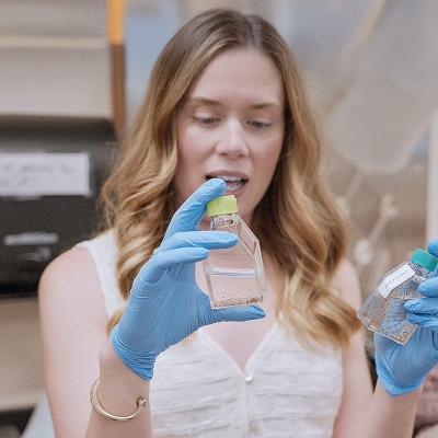 Maddelyn Harden holding lab vials