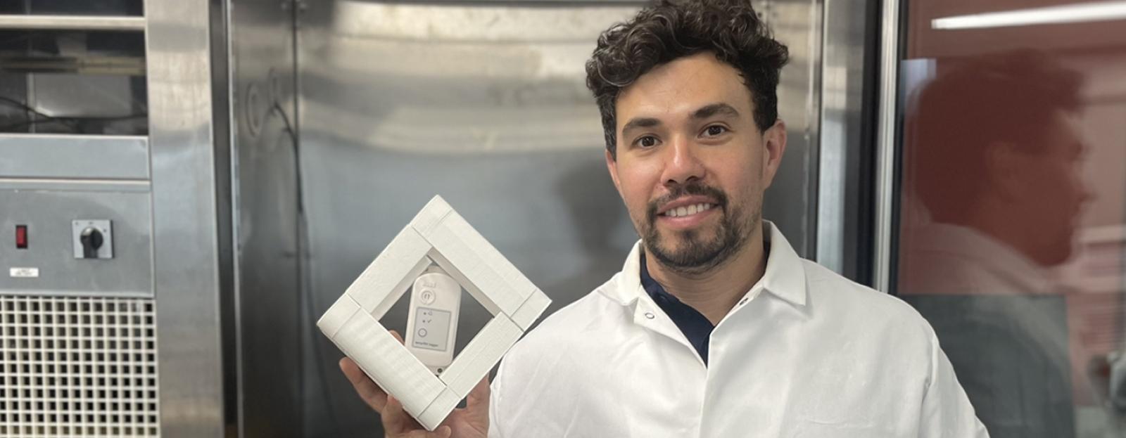 Matt Aguayo holding a HOBO data logger