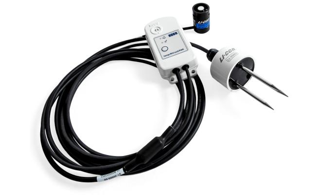 MX2310 studio photo - a small white device connected to 2 senor devices, connected by a long black cable.