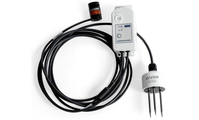 MX2311 studio photo - a small white device connected to 2 senor devices, connected by a long black cable.