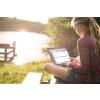 Woman by lake looking at data on software
