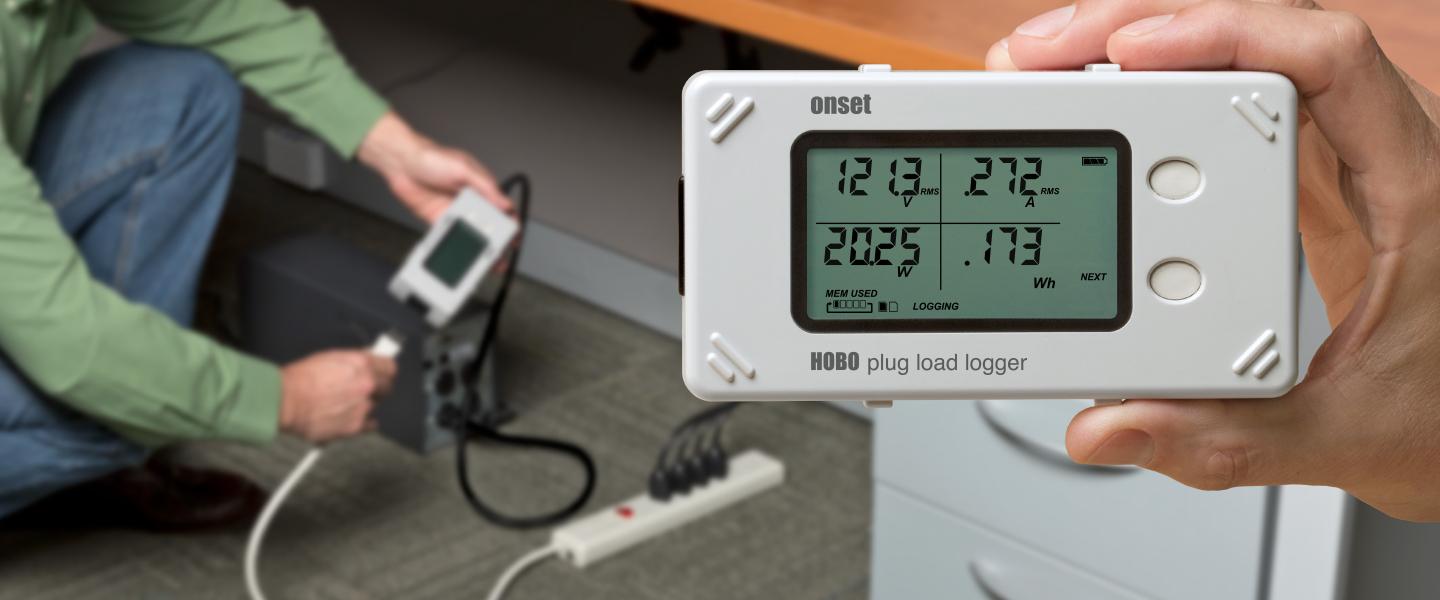 HOBO Plug load logger being installed in an office to monitor energy parameters