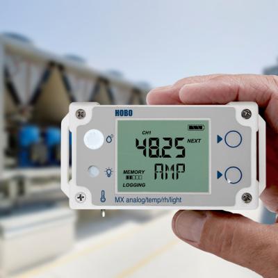 Data logger in hand screen showing weather conditions on rooftop